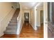 Inviting foyer with hardwood floors, a staircase with carpet and a white railing, and neutral wall paint at 1652 Weymouth Ct, Tucker, GA 30084