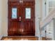 Elegant, stained double front doors with decorative glass inserts and white trim at 1652 Weymouth Ct, Tucker, GA 30084