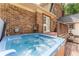 Exterior of home features a relaxing hot tub with deck, and wooded area at 1652 Weymouth Ct, Tucker, GA 30084
