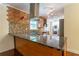 Open kitchen with granite island, modern appliances, custom cabinets, and stylish backsplash at 1652 Weymouth Ct, Tucker, GA 30084
