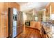 Bright kitchen featuring stainless steel appliances, granite countertops, and custom wood cabinets at 1652 Weymouth Ct, Tucker, GA 30084