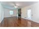 Spacious living room featuring a stone fireplace, hardwood floors, and natural light at 1652 Weymouth Ct, Tucker, GA 30084