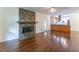 Open-concept living room featuring a stacked stone fireplace and hardwood floors at 1652 Weymouth Ct, Tucker, GA 30084