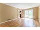 Bright living room with hardwood floors, neutral walls, and french doors with ample natural light at 1652 Weymouth Ct, Tucker, GA 30084