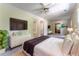 Comfortable bedroom with a king bed, dresser, mounted tv and ceiling fan at 1652 Weymouth Ct, Tucker, GA 30084