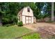 Outbuildings with barn doors and wood ramp with nicely landscaped yard at 1652 Weymouth Ct, Tucker, GA 30084