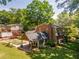 Stunning rear exterior of home featuring lush landscaping and covered patio at 1652 Weymouth Ct, Tucker, GA 30084