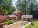 Rear exterior of home with hot tub, patio, and landscaped yard with mature trees at 1652 Weymouth Ct, Tucker, GA 30084