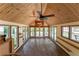 Bright sunroom with wood-paneled ceiling and walls of windows offering natural light at 1652 Weymouth Ct, Tucker, GA 30084