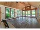 Inviting sunroom with wood ceilings, large windows, and views of the landscaped backyard at 1652 Weymouth Ct, Tucker, GA 30084