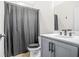 Traditional bathroom includes a modern vanity, commode and shower with gray shower curtain at 2744 Bell Se Dr, Smyrna, GA 30080