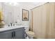 Clean bathroom with a modern vanity, neutral-toned shower curtain, and a well-lit mirror, creating a functional space at 2744 Bell Se Dr, Smyrna, GA 30080