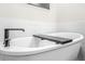 Close-up of a freestanding tub with a black faucet and wooden shelf for relaxation at 2744 Bell Se Dr, Smyrna, GA 30080