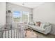 A bright Bedroom with crib, sofa and soft pastel accents for a cozy space at 2744 Bell Se Dr, Smyrna, GA 30080