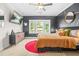 A bedroom featuring a large window view and decorative accent wall at 2744 Bell Se Dr, Smyrna, GA 30080