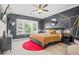 This bedroom features a bold accent wall, a large window, and stylish furnishings at 2744 Bell Se Dr, Smyrna, GA 30080