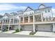 Exterior view of townhomes with porches and garages at 2744 Bell Se Dr, Smyrna, GA 30080