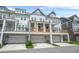 Back exterior view of townhomes with porches and garages at 2744 Bell Se Dr, Smyrna, GA 30080