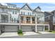 Back exterior view of townhomes with porches and garages at 2744 Bell Se Dr, Smyrna, GA 30080