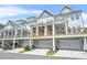 Exterior view of townhomes with porches and garages at 2744 Bell Se Dr, Smyrna, GA 30080