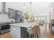 Open-concept kitchen featuring a quartz countertop island, pendant lights, and stainless steel appliances at 2744 Bell Se Dr, Smyrna, GA 30080