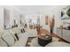 Bright living room featuring hardwood floors, modern decor, and an open floor plan to the kitchen and dining area at 2744 Bell Se Dr, Smyrna, GA 30080