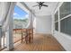 A porch with wood floors, white curtains, a ceiling fan, and table with chairs at 2744 Bell Se Dr, Smyrna, GA 30080