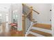 Elegant staircase featuring hardwood steps, black iron spindles, and a light wood handrail, adding charm to the entryway at 2744 Bell Se Dr, Smyrna, GA 30080
