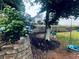 Beautiful backyard featuring lush landscaping, a retaining wall, and play swings at 2945 Dogwood Creek Parkway, Duluth, GA 30096