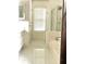 Bathroom featuring a large soaking tub, separate glass shower, and neutral tile flooring at 2945 Dogwood Creek Parkway, Duluth, GA 30096