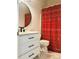 Bathroom with a modern vanity, decorative mirror, patterned shower curtain, and toilet at 2945 Dogwood Creek Parkway, Duluth, GA 30096