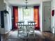 Cozy dining area with white table and chairs, complemented by bright curtains and natural lighting at 2945 Dogwood Creek Parkway, Duluth, GA 30096