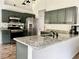Kitchen featuring stainless steel appliances, gray cabinets and a island with white granite countertops at 2945 Dogwood Creek Parkway, Duluth, GA 30096