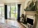Living room with large windows, hardwood floors, a fire place, and an elephant painting over the fireplace at 2945 Dogwood Creek Parkway, Duluth, GA 30096