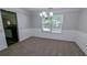 Elegant dining room with wainscoting, a modern chandelier, and a view into the adjacent kitchen at 3881 Micah Ln, Ellenwood, GA 30294