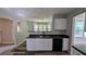 Modern kitchen featuring white cabinets and new appliances overlooking the living and dining areas at 3881 Micah Ln, Ellenwood, GA 30294