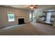 Open-concept living room with a fireplace and view to a kitchen with white cabinets at 3881 Micah Ln, Ellenwood, GA 30294
