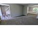 Open-concept living space with new carpet and flooring, connecting the living room and dining area at 3881 Micah Ln, Ellenwood, GA 30294