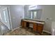 Main bathroom featuring dual sinks with granite countertops and a linen closet at 3881 Micah Ln, Ellenwood, GA 30294