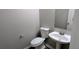Practical powder room featuring a pedestal sink, toilet and a neutral color palette at 3881 Micah Ln, Ellenwood, GA 30294