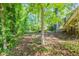 A lush backyard featuring mature trees, offering shade and privacy, great for outdoor enjoyment at 5372 Martins Crossing Rd, Stone Mountain, GA 30088
