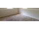 Basement space with neutral paint and carpet, bathed in natural light from two windows at 5372 Martins Crossing Rd, Stone Mountain, GA 30088