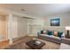 Virtually staged basement showcasing neutral paint and flooring, plus a stone fireplace and decor at 5372 Martins Crossing Rd, Stone Mountain, GA 30088