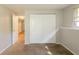 Basement featuring neutral paint, carpet, and a closet with bi-fold doors at 5372 Martins Crossing Rd, Stone Mountain, GA 30088