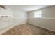 Unfinished basement with neutral paint, carpet, and a stone fireplace, ready for customization at 5372 Martins Crossing Rd, Stone Mountain, GA 30088