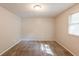 Empty bedroom showcases neutral walls, carpet floors, a ceiling light and natural light from the window at 5372 Martins Crossing Rd, Stone Mountain, GA 30088