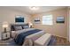 Staged bedroom with bed, side tables, lamps, decorative art, and natural light from the window at 5372 Martins Crossing Rd, Stone Mountain, GA 30088