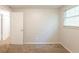 Empty bedroom has carpet floors, neutral walls and natural light from a window at 5372 Martins Crossing Rd, Stone Mountain, GA 30088
