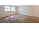 Bright bedroom features neutral walls, carpet flooring and natural light from the double windows at 5372 Martins Crossing Rd, Stone Mountain, GA 30088
