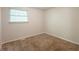 This bedroom features neutral walls, carpet floors and natural light from the window at 5372 Martins Crossing Rd, Stone Mountain, GA 30088